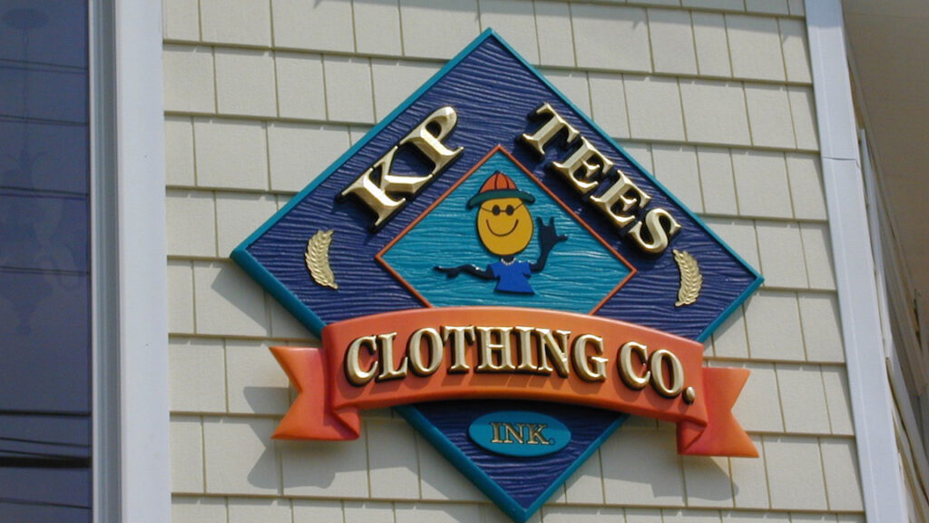 Carved gold leaf retail store sign on Long Beach Island NJ with dimensional wood lettering and hand applied gold leaf finish