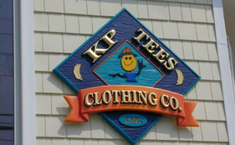 Carved gold leaf retail store sign on Long Beach Island NJ with dimensional wood lettering and hand applied gold leaf finish