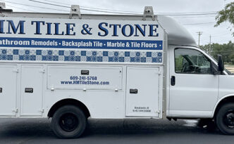 HM Tile & Stone box truck transformed with a new commercial vehicle wrap and professional business branding