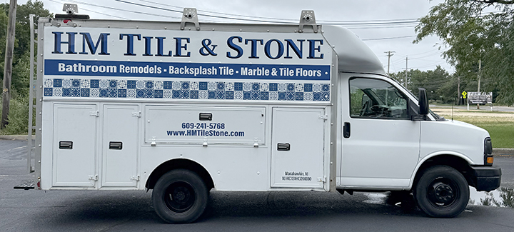HM Tile & Stone box truck transformed with a new commercial vehicle wrap and professional business branding