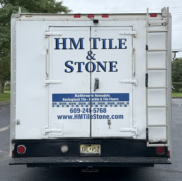 Finished HM Tile & Stone box truck graphics giving an older used work vehicle a clean fresh professional appearance
