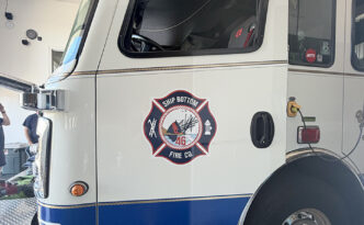 New Ship Bottom Volunteer Fire Company Maltese cross design preserving the department's historic shield and Fortuna shipwreck illustration