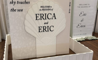 Custom coastal wedding welcome display for a Jersey Shore wedding featuring layered panels, dimensional seashell detail and coordinated event signage