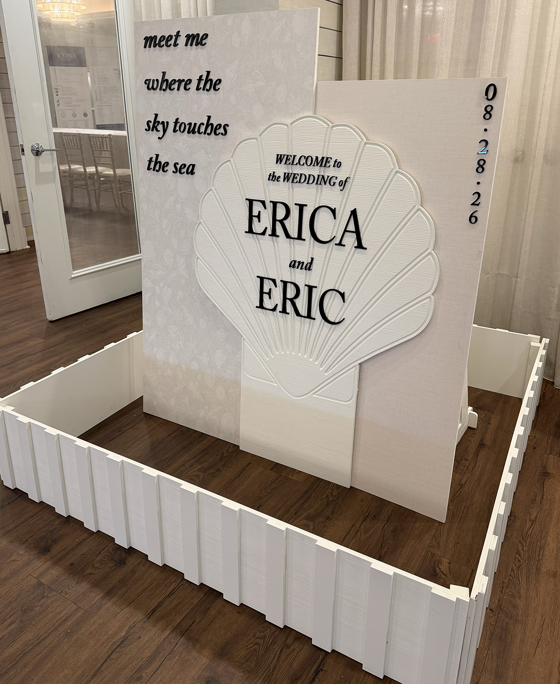 Custom Jersey Shore wedding welcome sign featuring layered neutral panels, a large dimensional seashell and personalized Erica and Eric wedding graphics