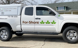 Passenger-side view of For-Shore Weed Control Toyota Tacoma with consistent fleet graphics and commercial vehicle branding
