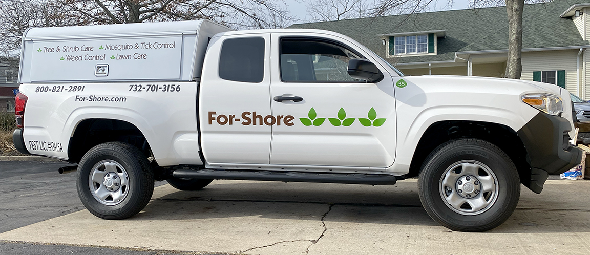 Passenger-side view of For-Shore Weed Control Toyota Tacoma with consistent fleet graphics and commercial vehicle branding