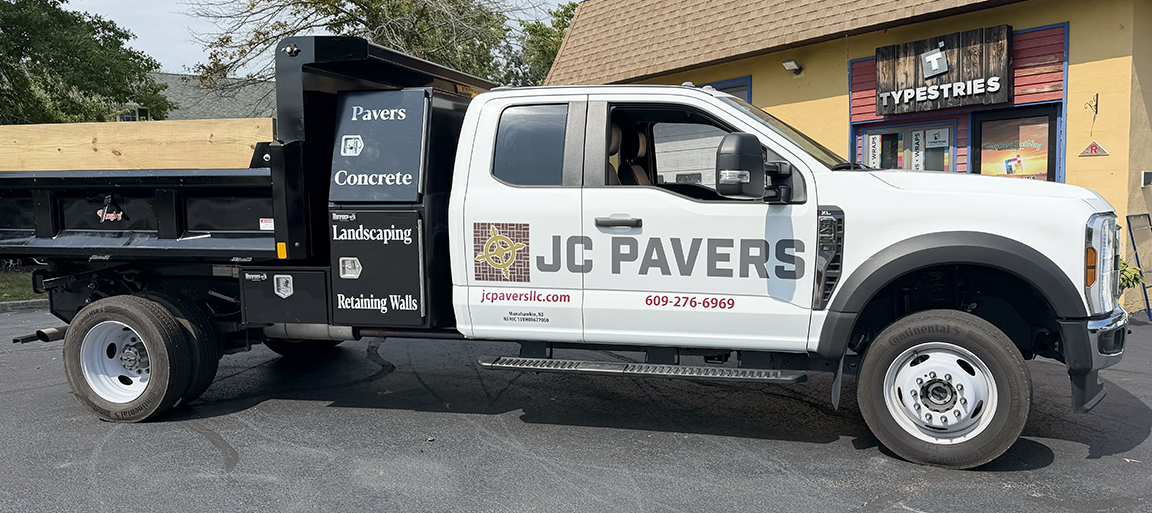 JC Pavers contractor dump truck with custom vehicle graphics, company branding, services, website and phone number in Manahawkin, New Jersey