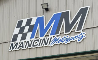Close-up of custom three-dimensional Mancini Motorsports exterior logo wall sign for a race shop in New Gretna, New Jersey