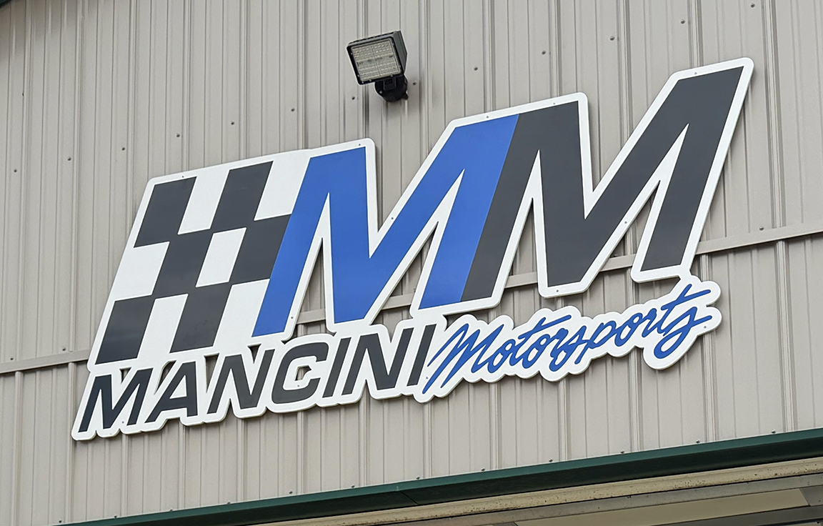 Close-up of custom three-dimensional Mancini Motorsports exterior logo wall sign for a race shop in New Gretna, New Jersey