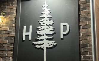Custom dimensional raised letter wall sign for Hollow Pines restaurant in West Creek NJ, blending woodsy and coastal branding elements