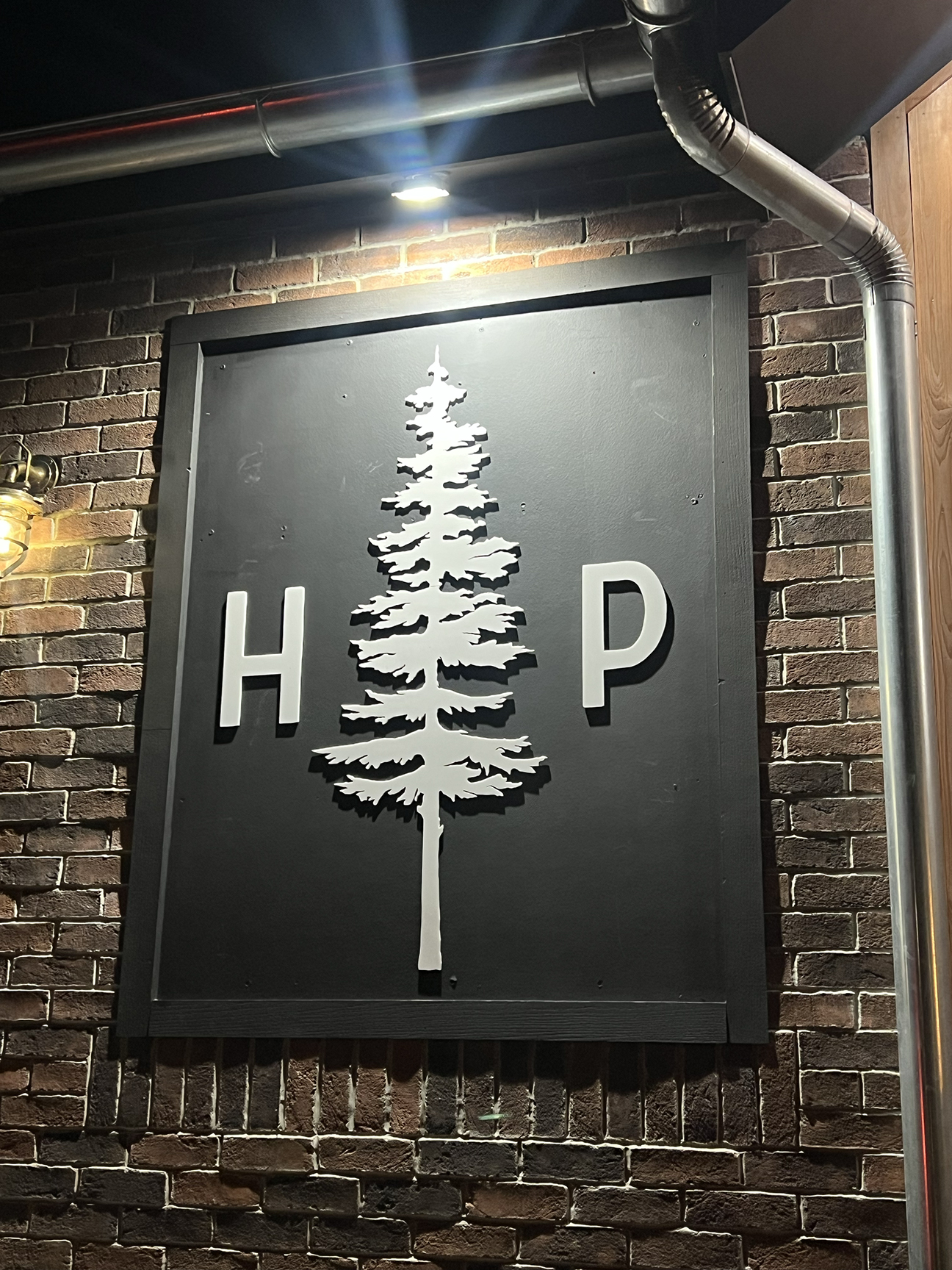 Custom dimensional raised letter wall sign for Hollow Pines restaurant in West Creek NJ, blending woodsy and coastal branding elements
