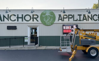 40-foot Anchor Appliance storefront sign in West Creek NJ with digitally printed graphics on aluminum composite panels installed over a corrugated metal building facade