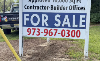 Large commercial real estate For Sale roadside sign on Route 9 in West Creek NJ advertising approved contractor-builder office space