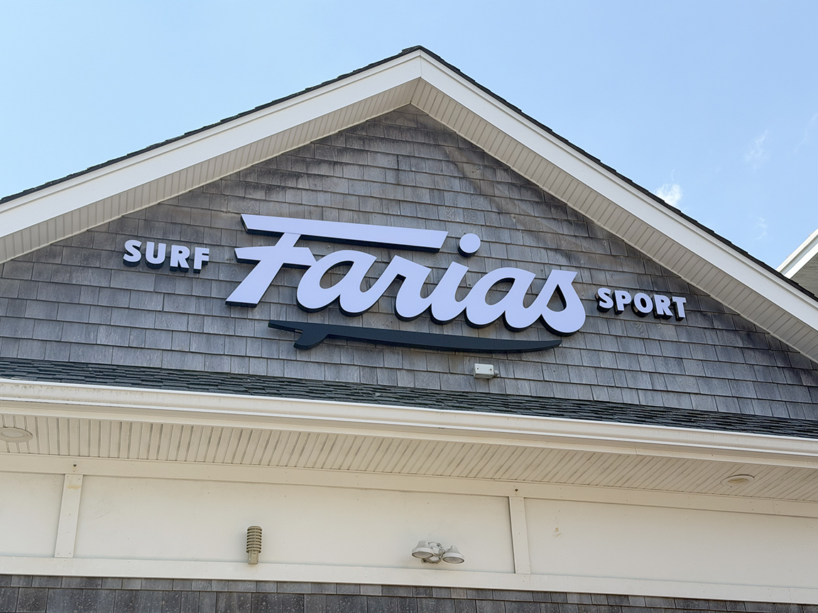 Full view of Farias Surf and Sport trimless channel letter storefront sign on cedar shingle gable in Ship Bottom NJ