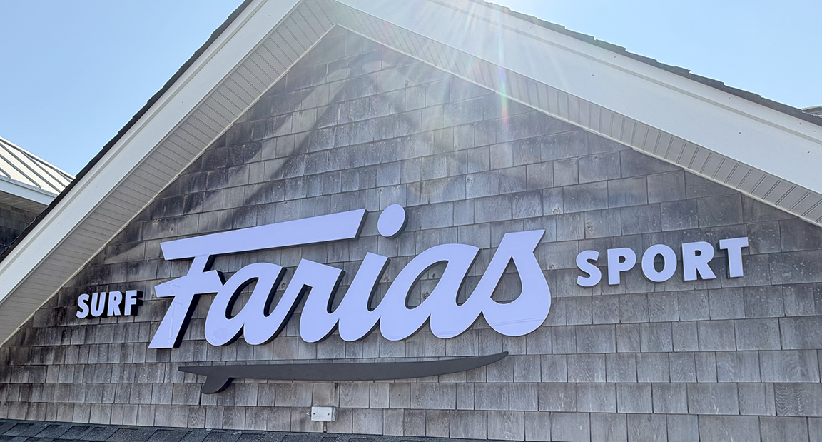 Close-up of Farias Surf and Sport script and trimless dimensional channel letters mounted to shingle storefront