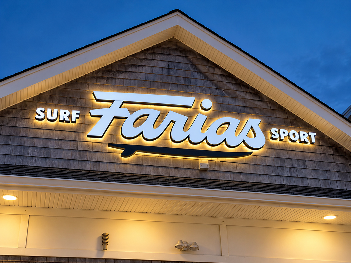 Conceptual simulated night view of Farias Surf and Sport lettering with warm halo glow; not an actual illuminated installation
