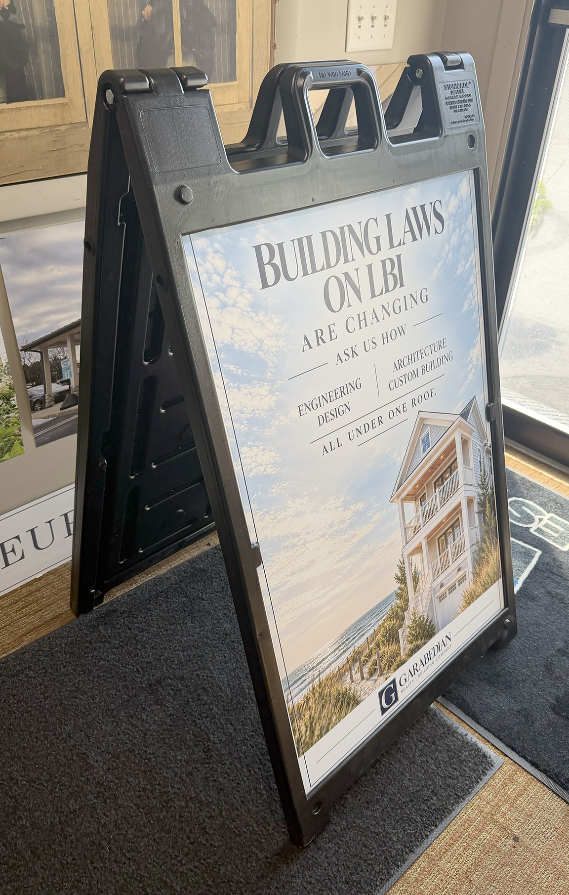 Portable A-frame advertising sign for Garabedian Group featuring Building Laws on LBI Are Changing messaging, engineering, design, architecture and custom building