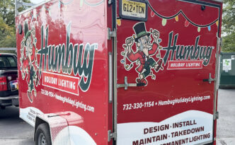 Humbug Holiday Lighting enclosed trailer wrap showing the rear and side holiday lighting branding in Ocean County, New Jersey