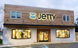 Jetty flagship store in Manahawkin, New Jersey, with halo-lit channel letter lettering and bird logo on the storefront at dusk