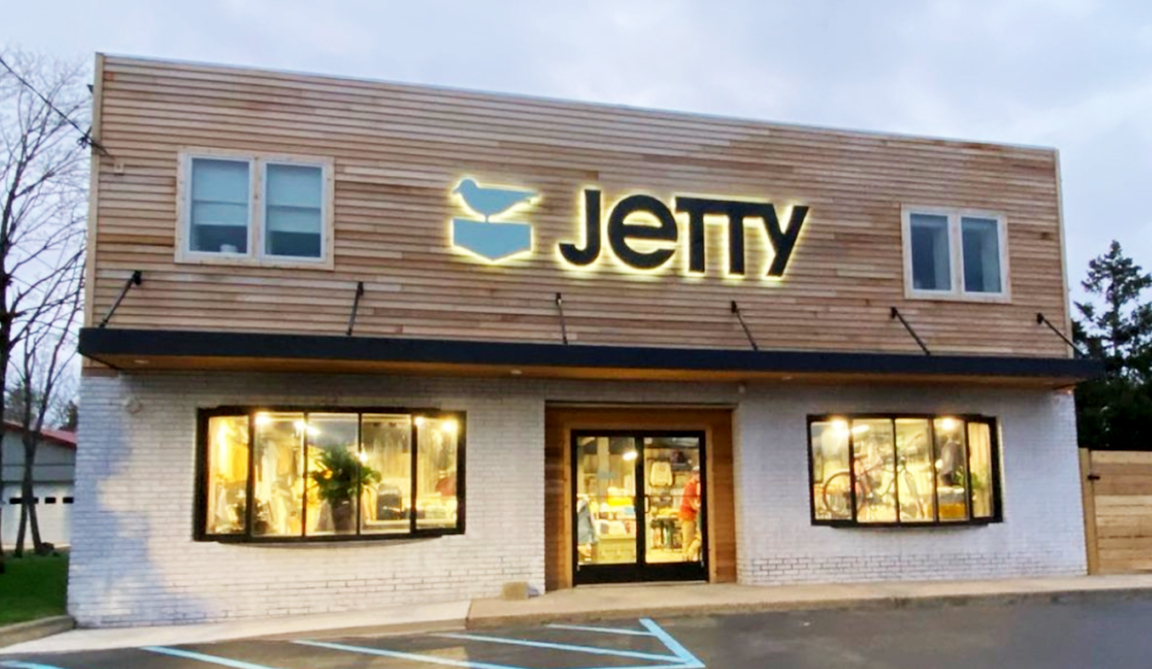 Jetty flagship store in Manahawkin with halo-lit channel letter sign and bird logo glowing at dusk