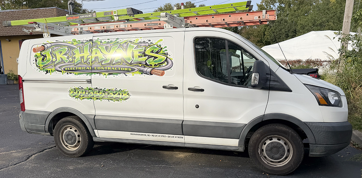 Passenger-side view of JR Haynes Electrical Contractors Ford Transit with large branded logo and electrical cable graphics