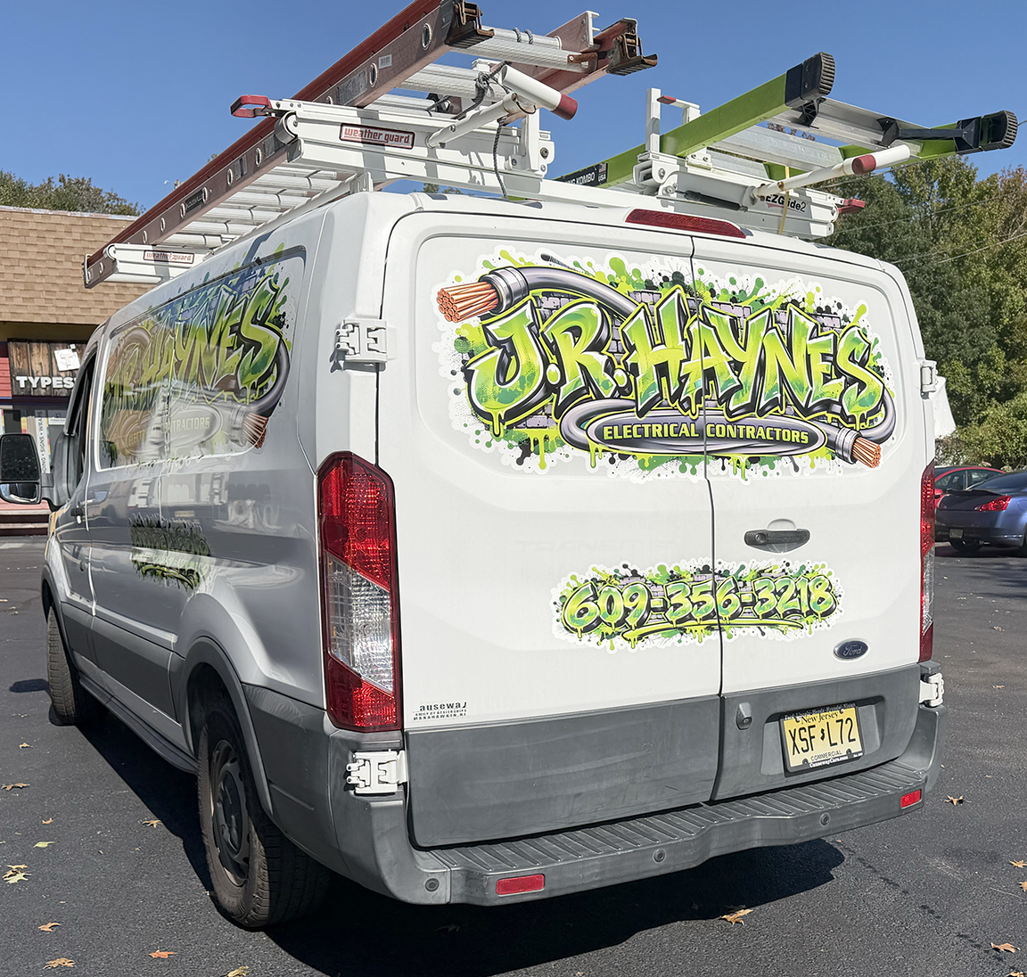 Rear doors of JR Haynes Electrical Contractors Ford Transit showing matching logo and phone number