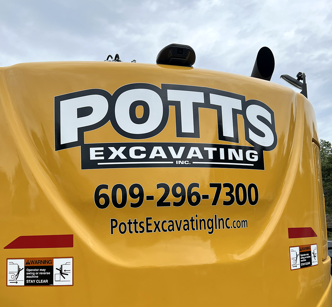Custom Potts Excavating branding graphics installed on yellow heavy equipment excavator in West Creek NJ with logo, phone number and website