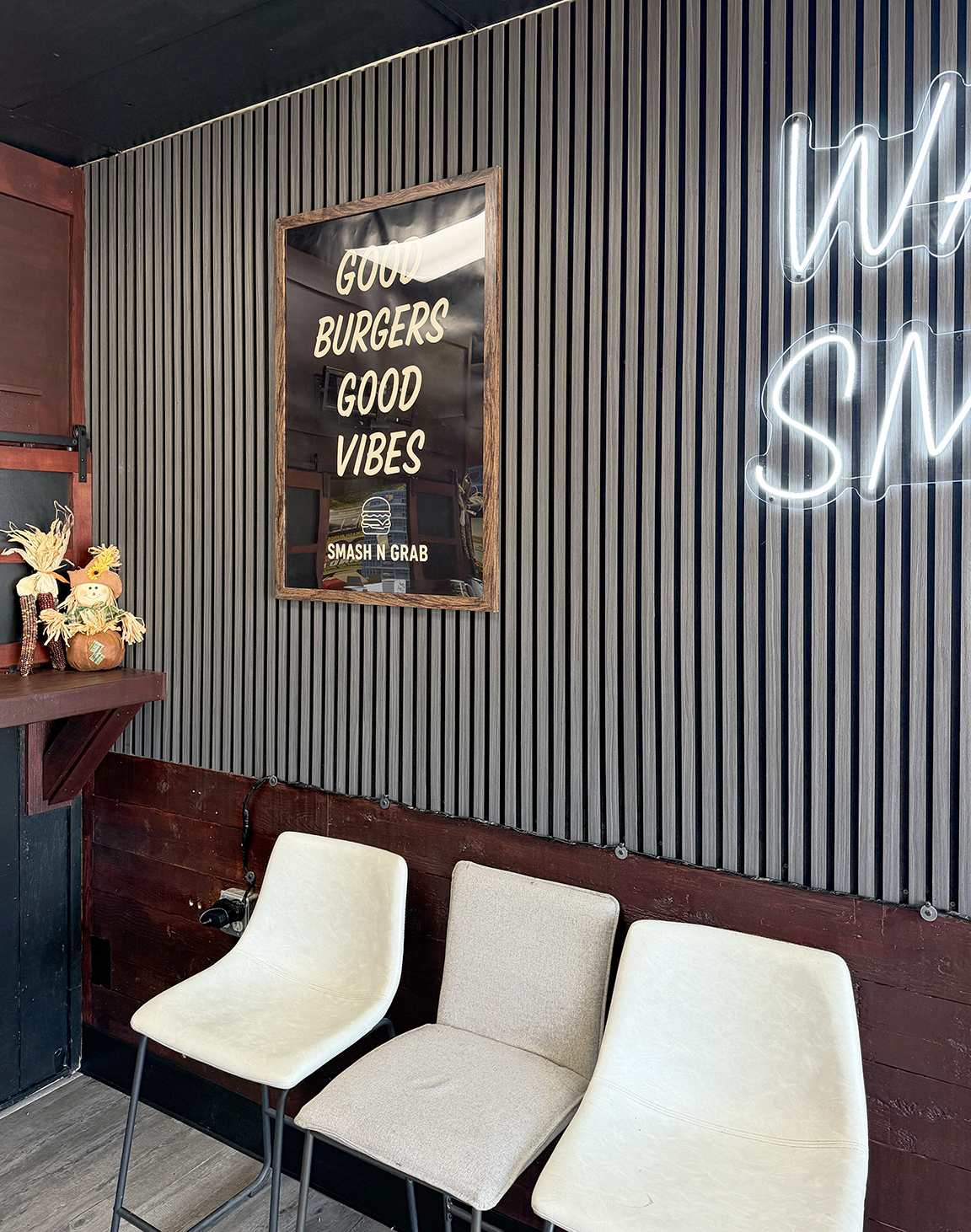 Custom changeable Smash N Grab restaurant poster display beside LED neon signage and architectural wall treatment in Manahawkin, New Jersey
