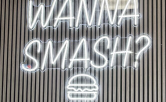 Custom white LED neon sign reading Wanna Smash with burger icon for Smash N Grab Burgers on Mill Creek Road in Manahawkin, New Jersey