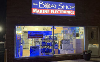 The Boat Shop Marine Electronics storefront at night with refreshed illuminated sign cabinet, new translucent sign face and LED illumination