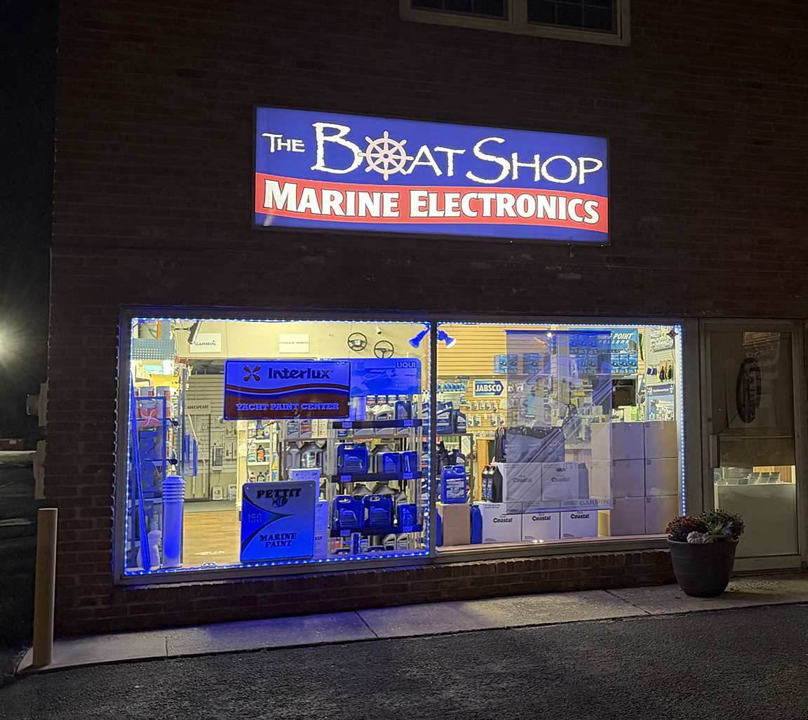The Boat Shop Marine Electronics storefront at night with refurbished backlit sign cabinet, new LED lighting and translucent sign face